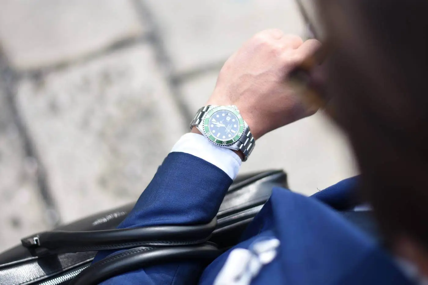 A man in a suit is wearing a watch.