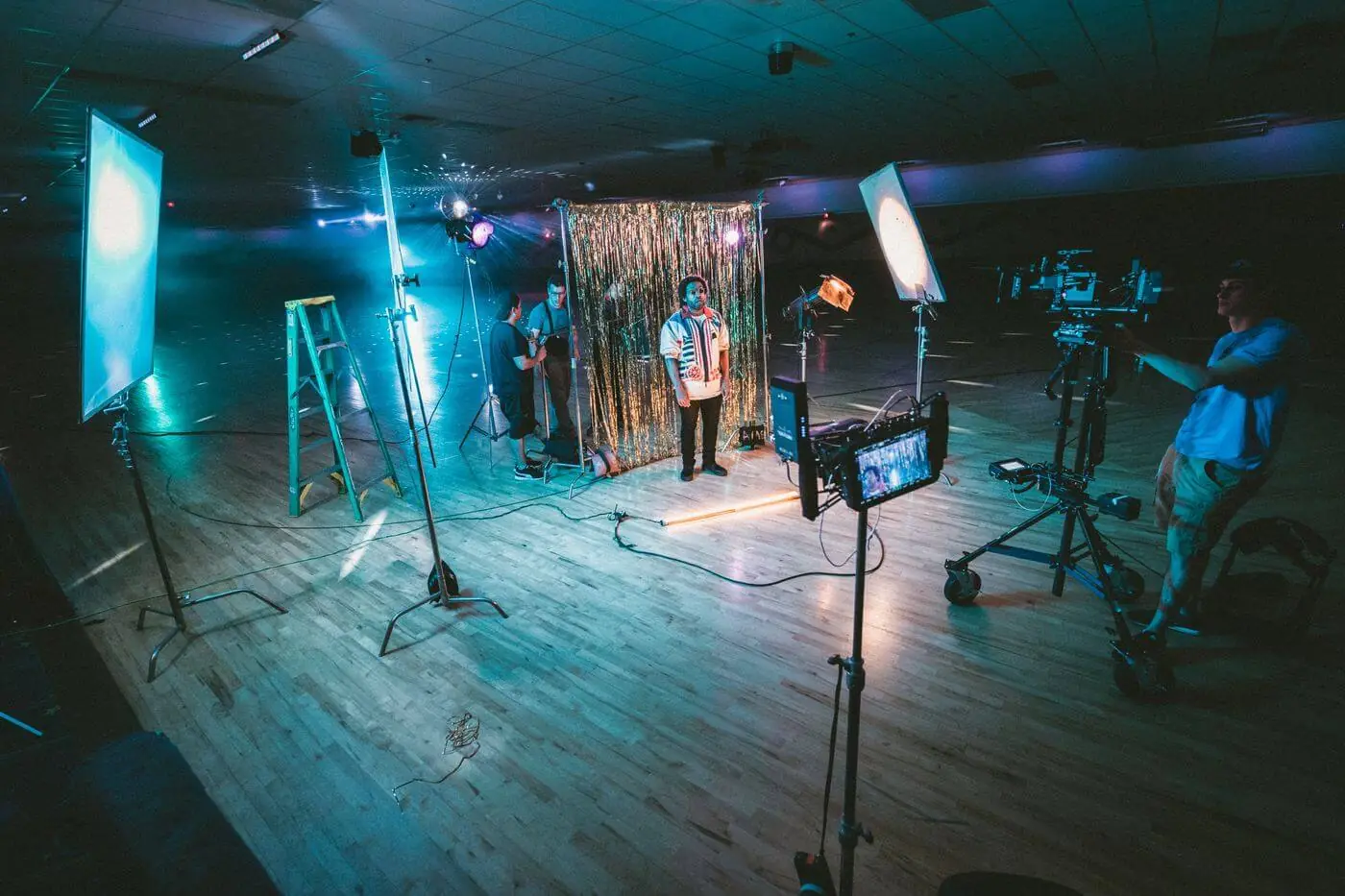 A group of people on a stage in a gymnasium.