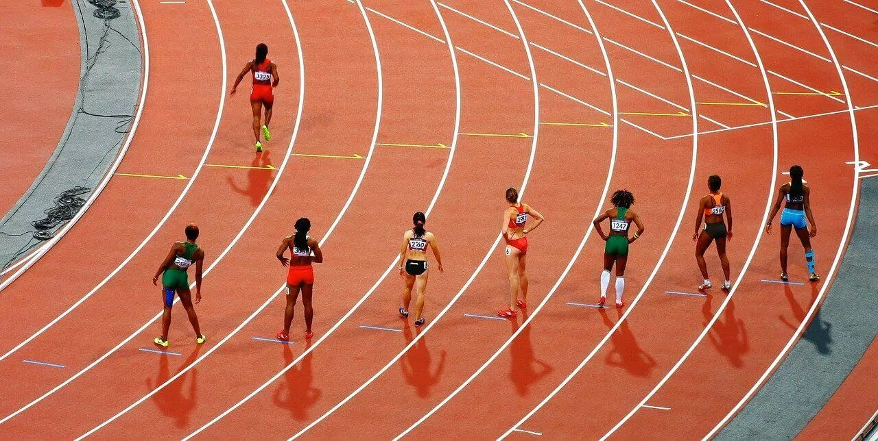A group of women are running on a track.