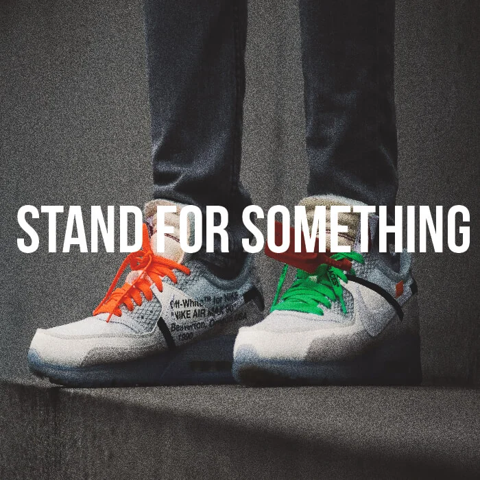 A pair of sneakers with the words stand for something.