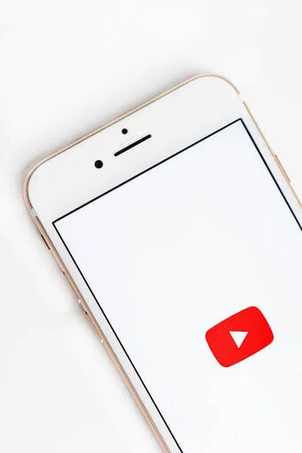 An iphone with a youtube logo on it.